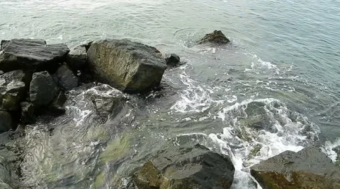 Water splashes in to beach rocks Stock Footage 40294733