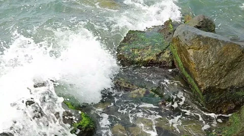 Water splashes in to beach rocks Stock Footage 40314397