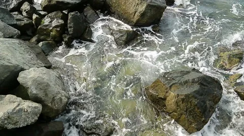 Water splashes in to beach rocks Stock Footage 40314418