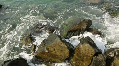 Water splashes in to beach rocks Stock Footage 40314421