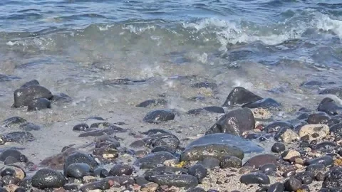 Water Splashes on The beach with round stones. Ocean. Teneriffe Stock Footage 248966839