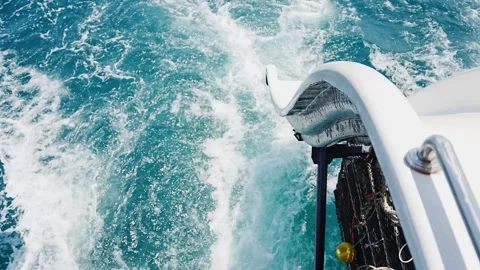 Water splashes behind a fast moving boat Stock Footage 304958732