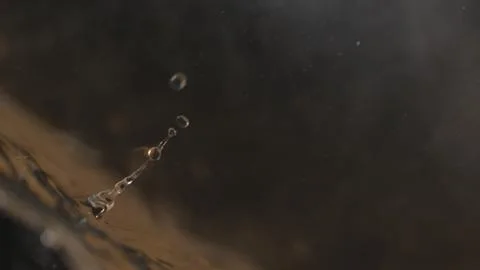 Water splashes up from the bottom left corner Stock Photos