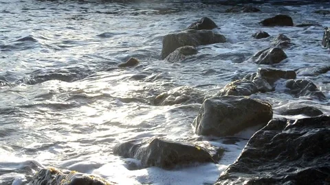 Water splashes close sunset sea waves storm stone wild beach Stock Footage 99188527