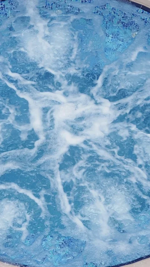 Water splashes create patterns in bright blue pool Stock Footage 314410150