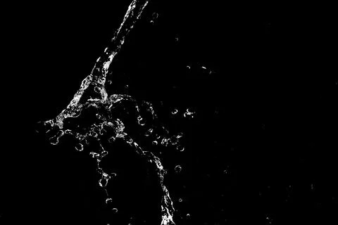 Water splashes isolated on black background. white jets with drops Stock Photos