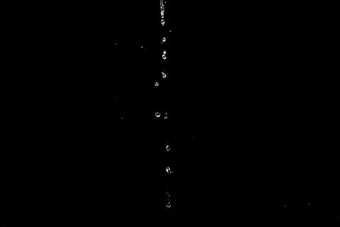 Water splashes isolated on black background. white jets with drops Stock Photos