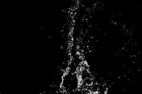 Water splashes isolated on black background. white jets with drops Stock Photos