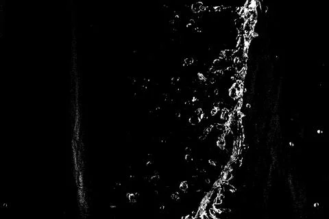 Water splashes isolated on black background. white jets with drops Stock Photos