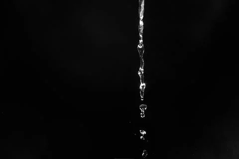 Water splashes isolated on black background. white jets with drops Stock Photos