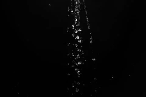 Water splashes isolated on black background. white jets with drops 스톡 사진
