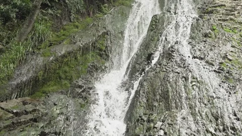 Water splashes over textured rock at Yeddi Gozel Waterfall in Gabala in a close Stock Footage 345258514