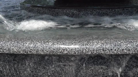 Water splashes pour over a stone fountain Stock Footage 213354492