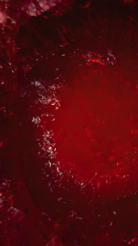 Water splashes in a red background in a dynamic display of movement Stock Footage 332211487