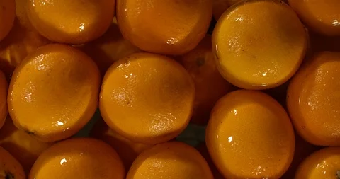 Water splashes on ripe oranges, slow motion macro shot Video stock 96545380