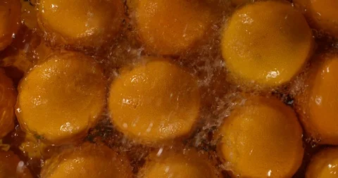 Water splashes on ripe oranges, slow motion macro shot Stock Footage 96545420