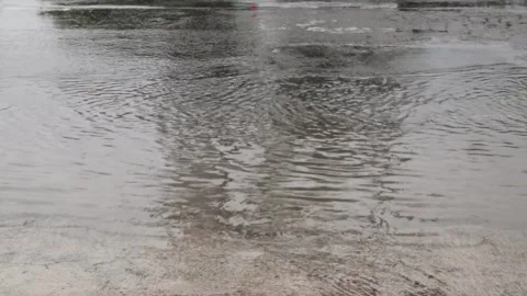 Water splashes on the road from the wheels of vehicles Stock Footage 296145221