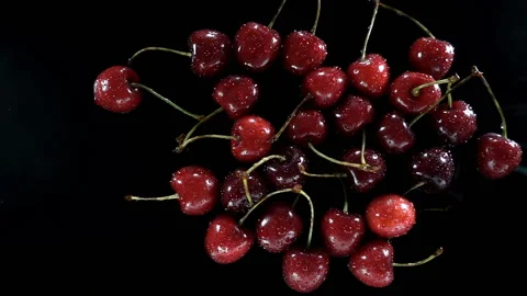 Water splashes in slow motion on a cherries on black Stock Footage 133222800