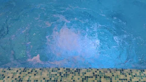 Water splashes in a swimming pool close up. Bubbling water in blue spa pool. Stock Footage 285292052
