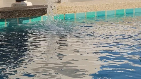 Water splashing action at a poolside location nature content serene environment Stock Footage 333889768