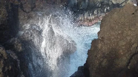Water Splashing Between Two Black Rocks in Slow Motion Video stock 150464998