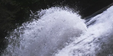 Water splashing while flowing from the mountain slope Stock Footage 103819684