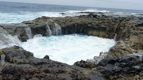 Water spout between the sea and the rocks Stock Footage 155129495