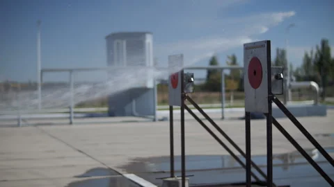 Water spray hitting firefighting training targets Stock Footage 321314437