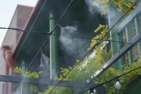 Water spray system to create a humidifier and cooling climate to reduce hot Stock Photos
