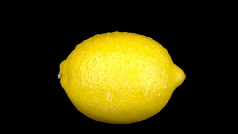 Water is sprayed on a lemon. On a black isolated background. Slow motion 库存影片 116813528