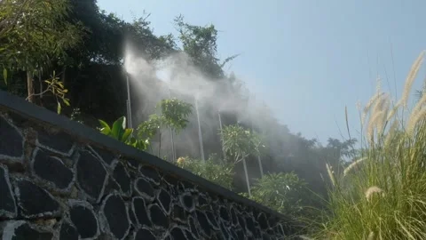 Water is sprayed from a misting device Video stock 251410260