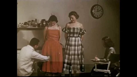 Water is sprayed on models in dresses to illustrate water-resistance and a small Stock Footage 118845779