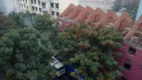 Water spraying car ejecting water to the demolition house to prevent dust Stock Footage 83683430