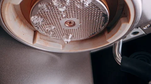 Water Spraying from Espresso Machine Shower Screen in Multiple Streams Close Up Stock Footage 331153328