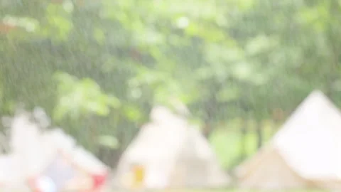 Water spraying in front of blurred campsite background Stock Footage 328644873