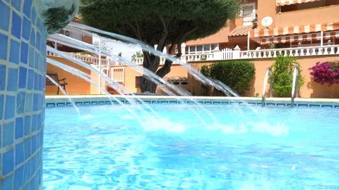 Water spraying in the pool during summertime Video stock 220060638