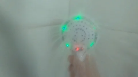 Water sprays out of shower head into the camera Stock Footage 127106974
