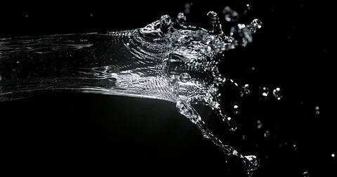 Water spurting out against Black Background, Slow motion 4K Stock Footage
