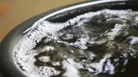 Water starts to overflow container Stock Footage 99424510