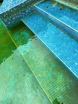 Water steps in a tiled pool showing different shades of blue and green with.. Stock Photos