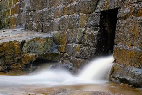 Water from stone wall Stock Photos