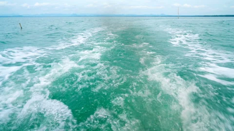 Water stream and smoke from the engine after fishing boat near the coast Video stock 235424186