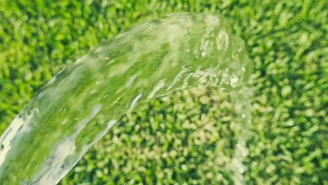 Water Stream Arcing Over Green Grass, Close Up Video stock 347813992