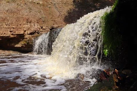 Water stream cascade falling on the rocks close up Stock Photos