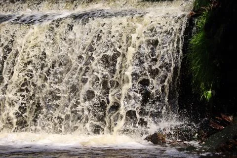 Water stream cascade falling on the rocks close up Stock Photos