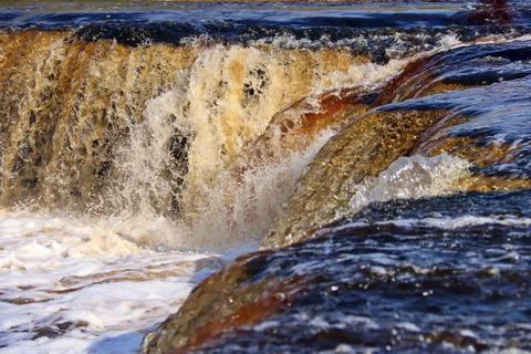 Water stream cascade falling on the rocks close up Stock Photos