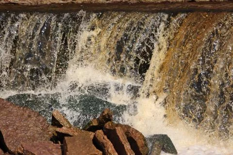 Water stream cascade falling on the rocks close up Stock Photos