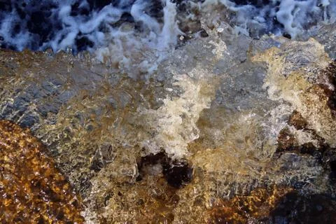 Water stream cascade falling on the rocks close up Stock Photos