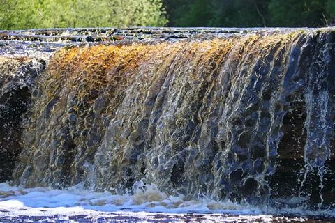 Water stream cascade falling on the rocks close up Stock Photos