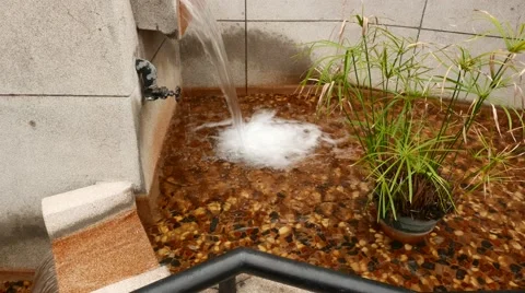 Water stream falling down in small decorative reservoir Stock Footage 49039237